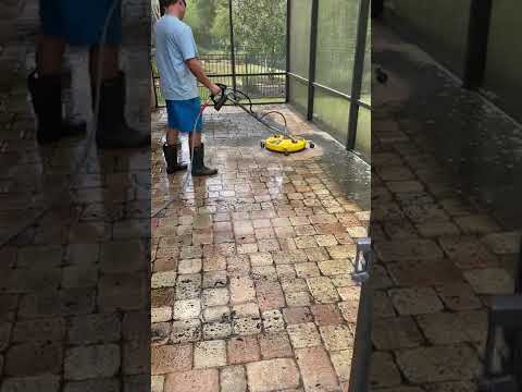 BEFORE: Surface clean patio floor with screen enclosure.